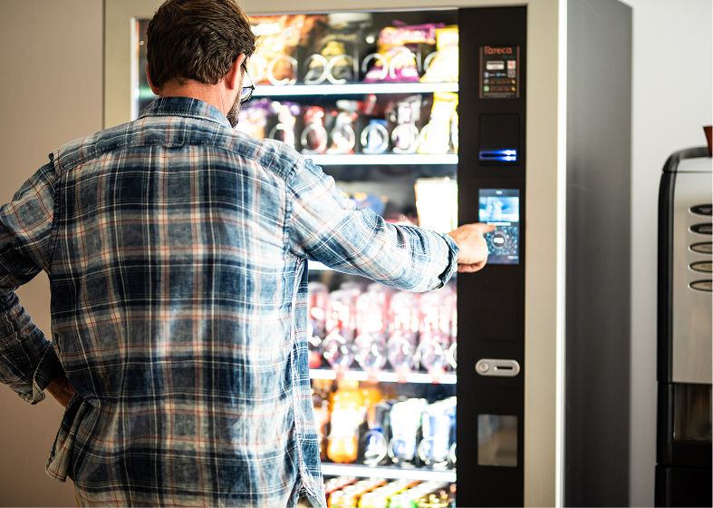 Customer choosing snack from vending machine