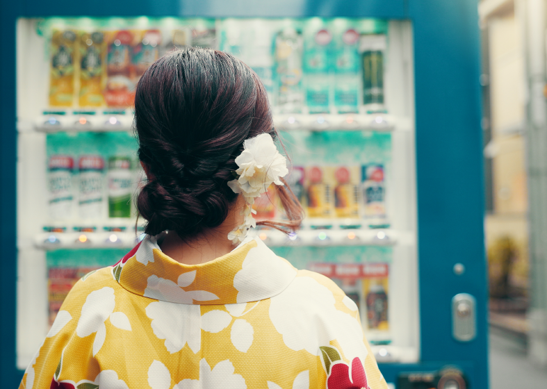 Woman in kimono at vending machine
