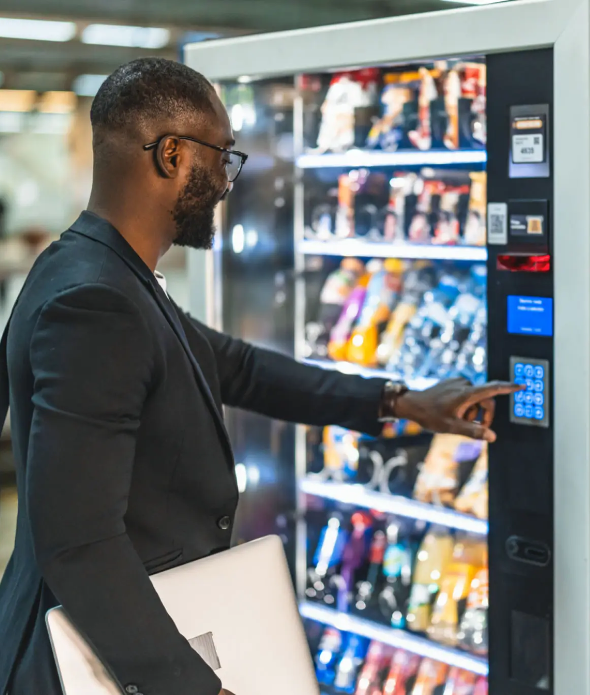 Businessman selecting snack from vending machine
